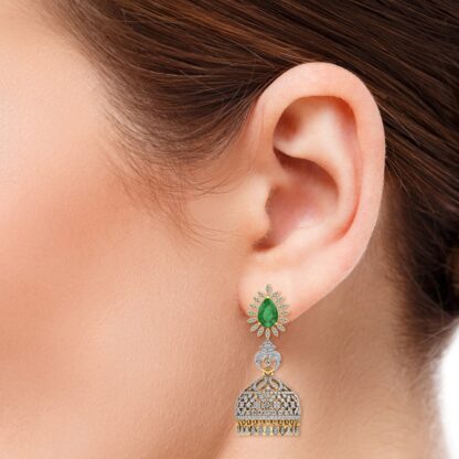 Yellow gold emerald diamond jhumka earrings, close-up of dome