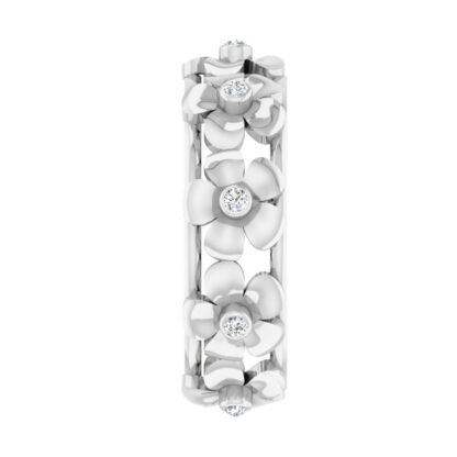 Side view of white gold openwork flower band showing three bezel-set diamond blooms