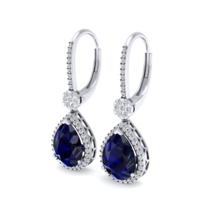 Angled view of white gold sapphire earrings showing the diamond flower connector
