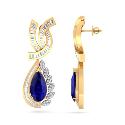 Close-up of yellow gold emerald diamond drop earring worn on a model's ear