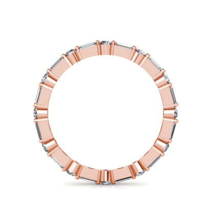 Through-finger view of rose gold baguette and round diamond station eternity band showing the band profile