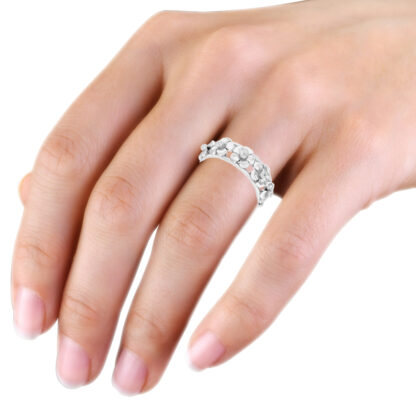 White gold bezel diamond flower band worn on the hand