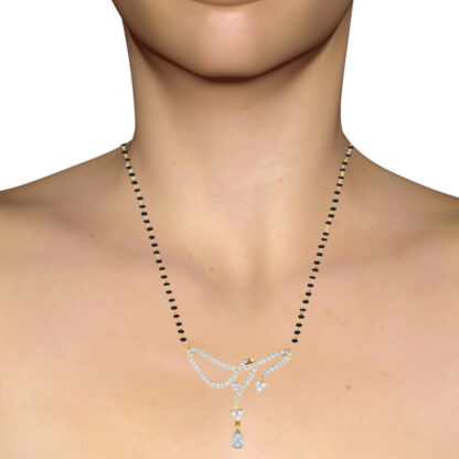 Yellow gold diamond bow knot mangalsutra worn on a model's neckline