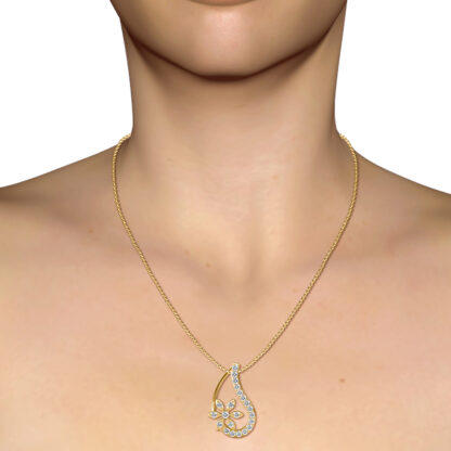 Yellow gold diamond teardrop floral pendant worn on a model's neckline