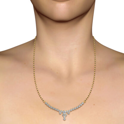 Yellow gold diamond mangalsutra worn on a model's neckline