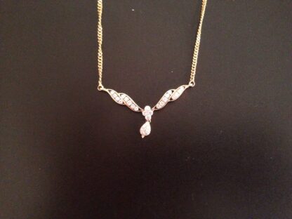 Close-up of yellow gold mangalsutra pendant showing the pear-shaped diamond drop