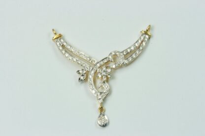Close-up of yellow gold mangalsutra pendant showing the pear-shaped diamond drop