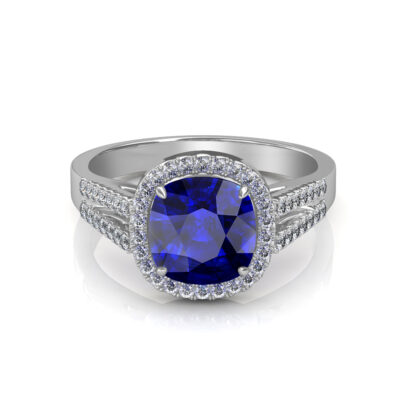 White gold cushion sapphire diamond halo ring worn on finger