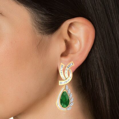 Angled view of yellow gold earrings showing the baguette diamond ribbon top