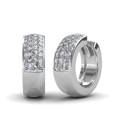 Angled view of white gold huggie hoop earrings showing the hinged clasp