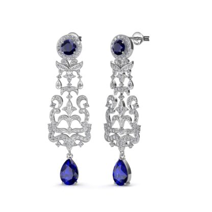 Front view of white gold chandelier earrings with diamond filigree and blue sapphires