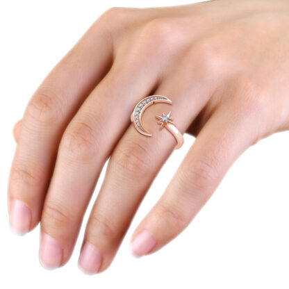 Rose gold crescent moon and star diamond ring worn on the hand
