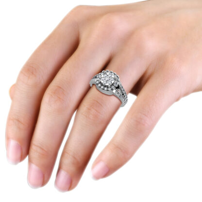 White gold or platinum illusion cluster halo split shank ring worn on the hand