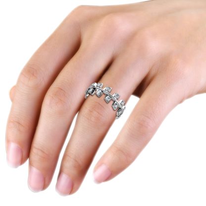 White gold or platinum staggered square bezel diamond band worn on the hand