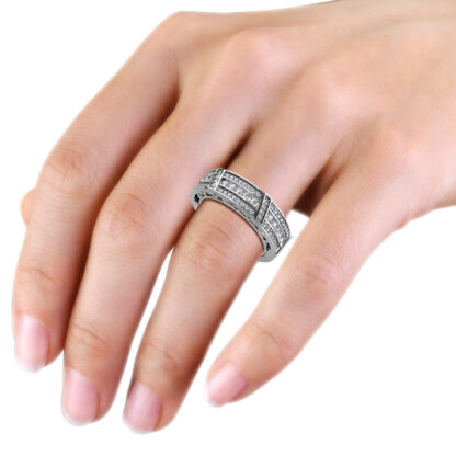 White gold or platinum wide channel and pave diamond band worn on the hand