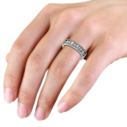 White gold or platinum beaded milgrain graduated diamond band worn on the hand