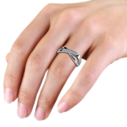 White gold or platinum pave diamond crossover wedding ring worn on the hand