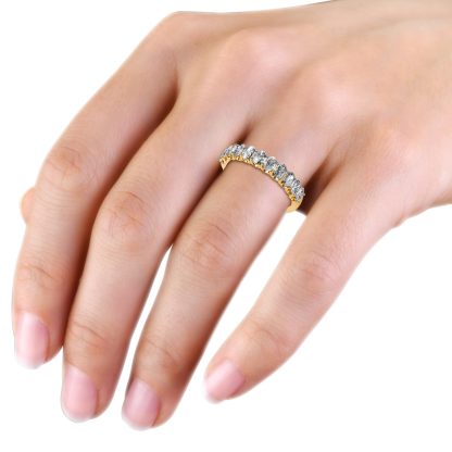 Yellow gold oval diamond half eternity ring worn on the hand