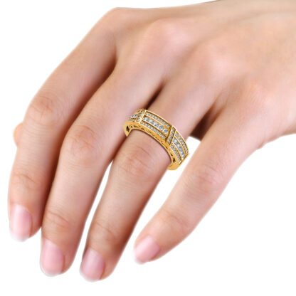 Yellow gold wide channel and pave diamond band worn on the hand