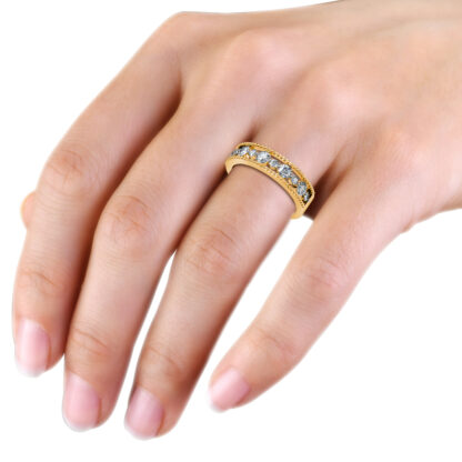 Yellow gold beaded milgrain graduated diamond band worn on the hand