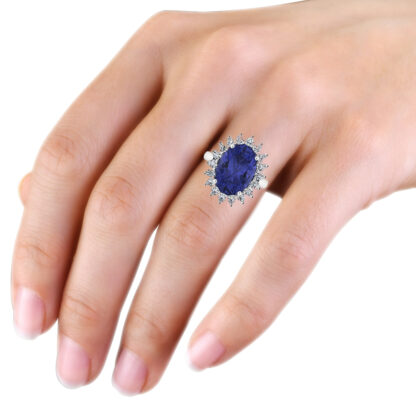 White gold oval sapphire diamond halo ring worn on hand