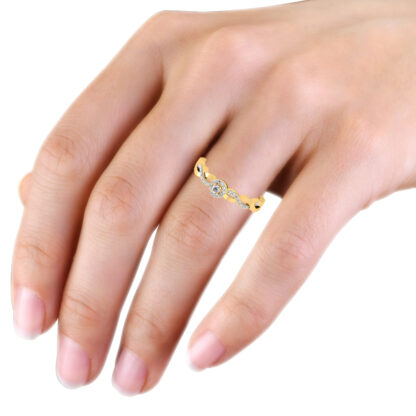 Yellow gold diamond halo ring worn on hand