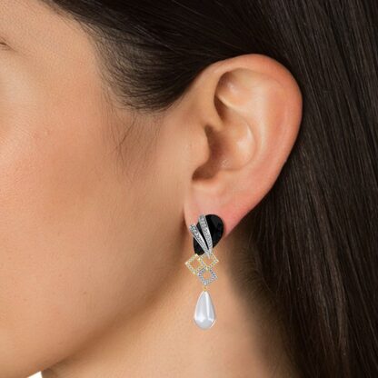Close-up of black onyx diamond and pearl drop earring worn on a model's ear