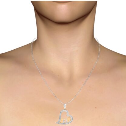 Yellow gold initials heart pendant worn on a model's neckline