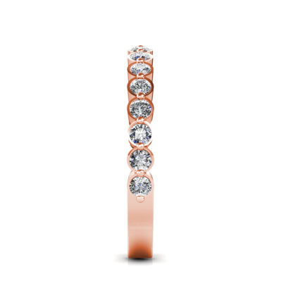 Side view of rose gold bezel-set diamond half eternity band showing the band depth and stone setting