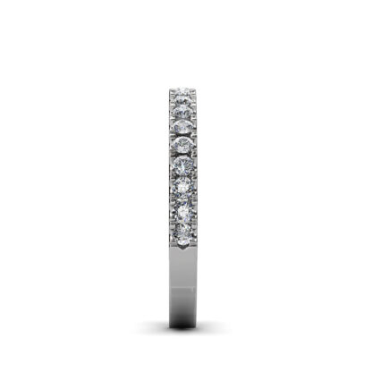 Side view of white gold or platinum prong-set diamond half eternity ring showing the band depth and stone setting