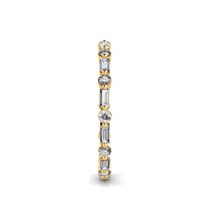 Side view of yellow gold baguette and round diamond station eternity band showing the band depth and setting