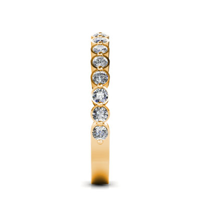 Side view of yellow gold bezel-set diamond half eternity band showing the band depth and stone setting